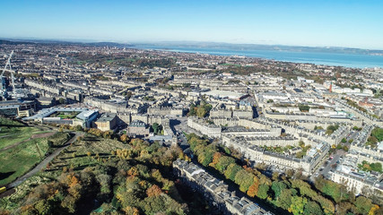 Aerial image looking across the north of the city of Edinburgh to the Firth of Forth on a bright autumn day.