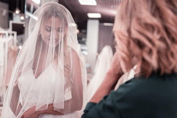 Best bride. Nice young woman smiling while standing in a beautiful wedding dress