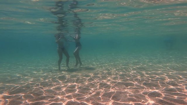 girls in thong play underwater
