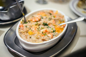 Traditional portuguese seafood dish with rice, shrimps and fresh egg yolk