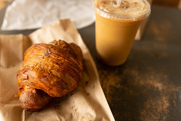 Croissant and cup of iced coffee at a local bakery in Raleigh, North Carolina