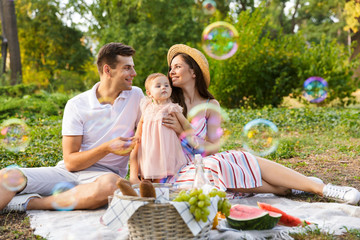 Positive young family with little baby girl spending time together