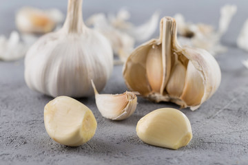 Garlic heads close-up on grey background. Condiment.