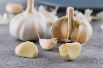 Garlic heads close-up on grey background. Condiment.