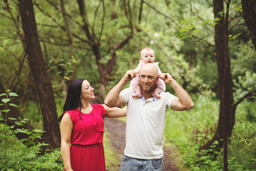 Father Mother and daughter baby in summer meadow park