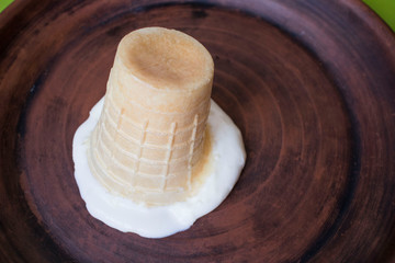 Fototapeta na wymiar inverted waffle ice cream in a clay plate, lots of sugar, obesity, diabetes