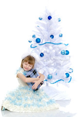 The girl at the Christmas tree.