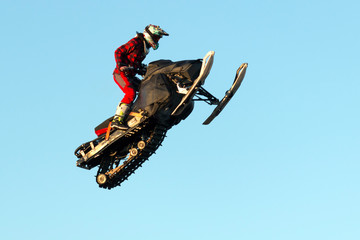 Freestyle motocross rider on snowmobile jump at fmx competitions