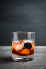 Old fashioned blackberry cocktail on the rustic background. Selective focus. Shallow depth of field.