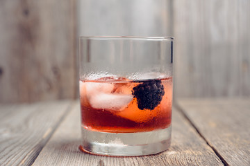 Old fashioned blackberry cocktail on the rustic background. Selective focus. Shallow depth of field.