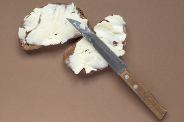 knife spreading butter on bread