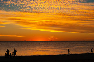 Fototapeta premium Landscape of silhouettes persons orange colors and contrast