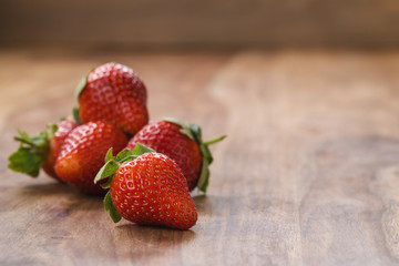 ripe strawberries on wood background with copy space