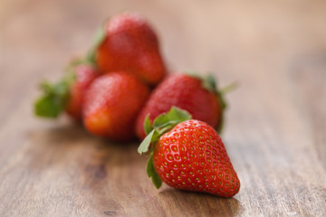 ripe strawberries on wood background