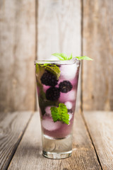 Blackberry mojito cocktail on the rustic background. Selective focus. Shallow depth of field. 