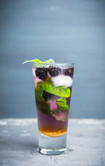 Blackberry mojito cocktail on the rustic background. Selective focus. Shallow depth of field. 