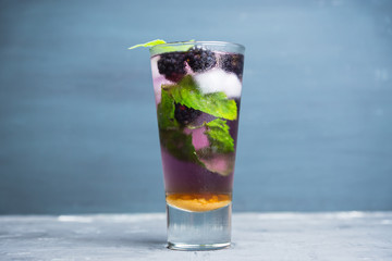 Blackberry mojito cocktail on the rustic background. Selective focus. Shallow depth of field. 