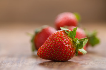 ripe strawberries on wood background