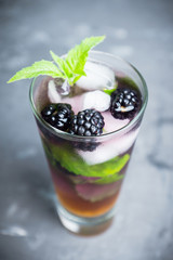 Blackberry mojito cocktail on the rustic background. Selective focus. Shallow depth of field. 