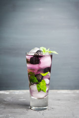 Blackberry mojito cocktail on the rustic background. Selective focus. Shallow depth of field. 