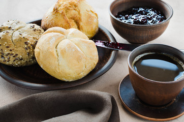 Simple breakfast: coffee americano, fresh buns and jam.