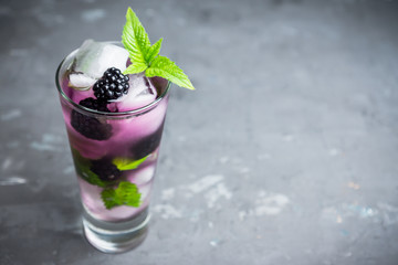 Blackberry mojito cocktail on the rustic background. Selective focus. Shallow depth of field. 