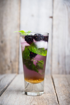 Blackberry mojito cocktail on the rustic background. Selective focus. Shallow depth of field. 