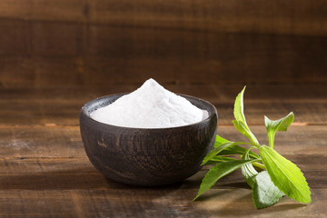 Natural sweetener in powder from stevia plant - Stevia rebaudiana. Top view