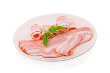 bacon rolls with herbs on the white plate