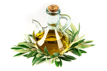 A photo of a cruet of olive oil with vibrant green leaves on a white background with copy space
