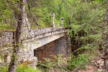 Impression of an old, abandoned bridge in the Italian Dolomites, somewhere along the route between...