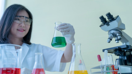 Asian woman scientists are testing different chemicals in the lab