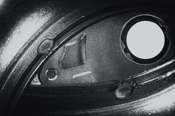 Unusual robotic eye in steampunk style in grayscale. Focused robot look. Monochrome background pattern close-up.