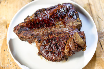 Round dish with grilled porterhouse beef steak