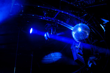 Disco ball with bright blue rays, night party background photo