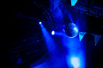 Disco ball with bright blue rays, night party background photo