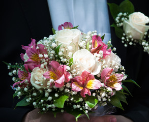 Groom holding in his hands wedding bridal bouquet of flowers