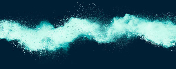 Blue powder explosion on black background. 
