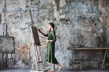 Woman painter in a green dress
