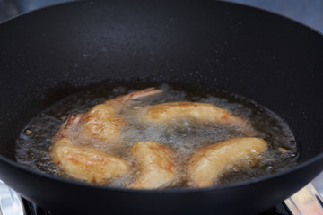 Cooking fried prawn with tempura flour in hot pan