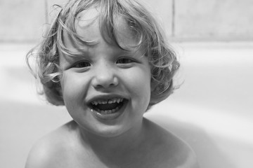 little baby playing in the bath