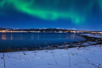 Fototapeta na wymiar Beautiful winter night landscape with northern lights, Aurora borealis, Gausvik, Lofoten Islands, Norway