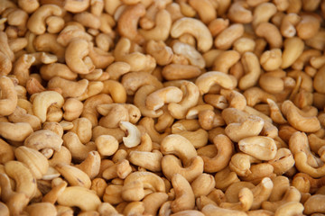 Cashews nut fried background. kernels of peeled nuts close up