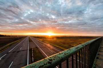 Two lanes highway at sunrise