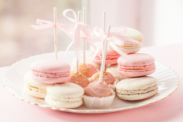 Delicious sweet buffet with pink cupcakes and macaroons. Candy Bar for celebration