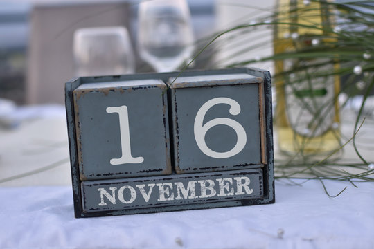 Wood blocks in box with date, day and month 16 November. Wooden blocks calendar