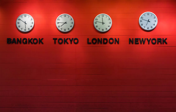 4 wall clocks on red wooden panel, show different time of world capital city. ( Bangkok, tokyo, london, newyork)