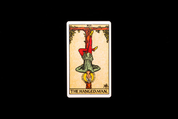 An individual major arcana tarot card isolated on black background. Hanged Man.
