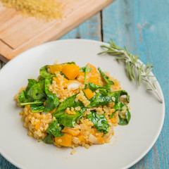 Bulgur with pumpkin and cutting board with ingredients