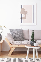 Mock-up painting on a white wall of an artistic living room interior with simple, wooden furniture...